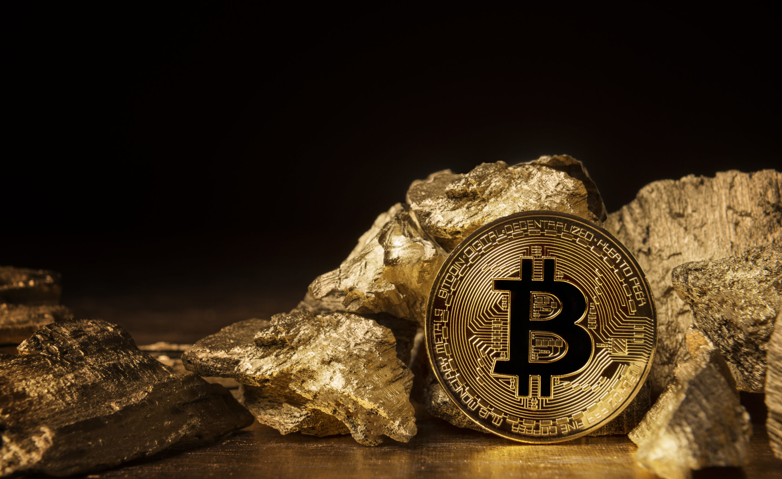 coin bitcoin next to pieces of gold