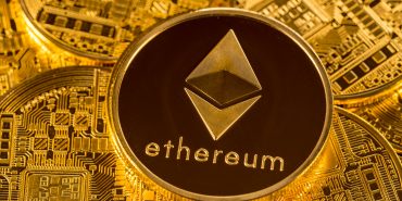 Stack of Ether coins with gold background